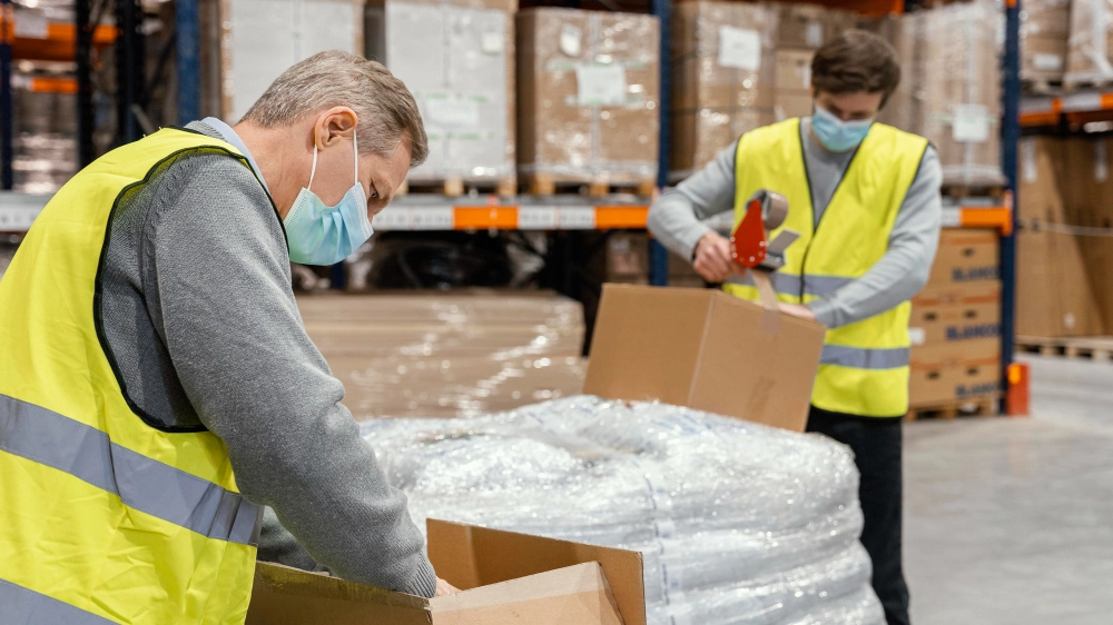 China to USA Shipping 1 Warehouse staff labeling cartons and pallets, repacking goods, and preparing export shipments for international freight.